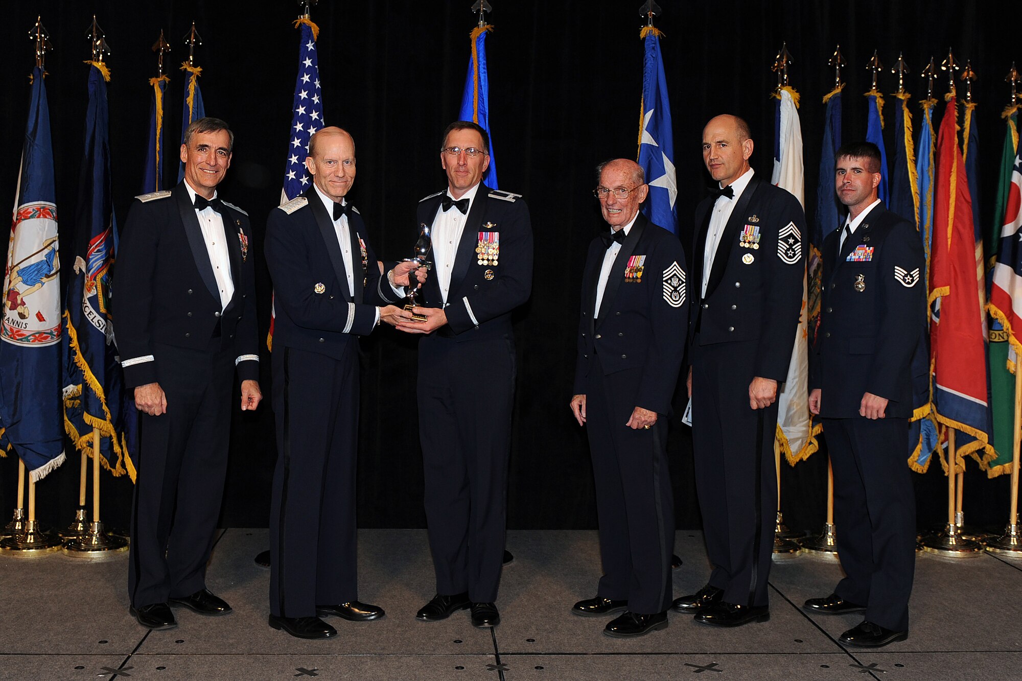 OFFUTT AIR FORCE BASE, Neb. - Col. Scott Vander Hamm 28th Bomber Wing commander, Ellsworth AFB, S.D., accepts the award for Outstanding Honor Guardsmen  of the Year from Gen. John D.W. Corley, Air Combat Command commander, on behalf of Senior Airman Timothy Johnson during the 2009 ACC Outstanding Airmen of the Year Recognition Gala at the Omaha Hilton April 15. Senior Airman Johnson is currently deployed and unable to attend the Gala. 

U.S. Air Force Photo by Josh Plueger