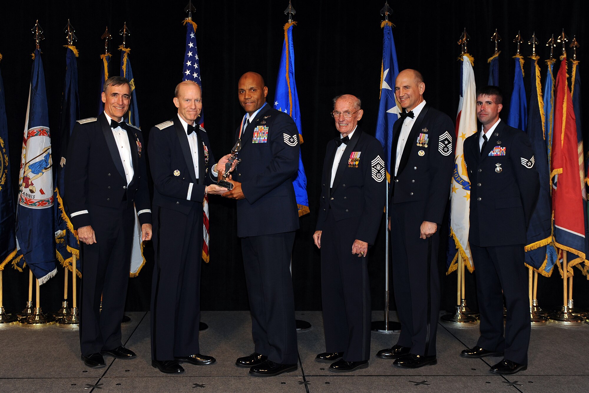 OFFUTT AIR FORCE BASE, Neb. - Tech. Sgt. Illyas Asaddullah, Nellis AFB, Nev., accepts the award for Outstanding NCO of the Year from Gen. John D.W. Corley, Air Combat Command commander, during the 2009 ACC Outstanding Airmen of the Year Recognition Gala at the Omaha Hilton April 15.

U.S. Air Force Photo by Josh Plueger