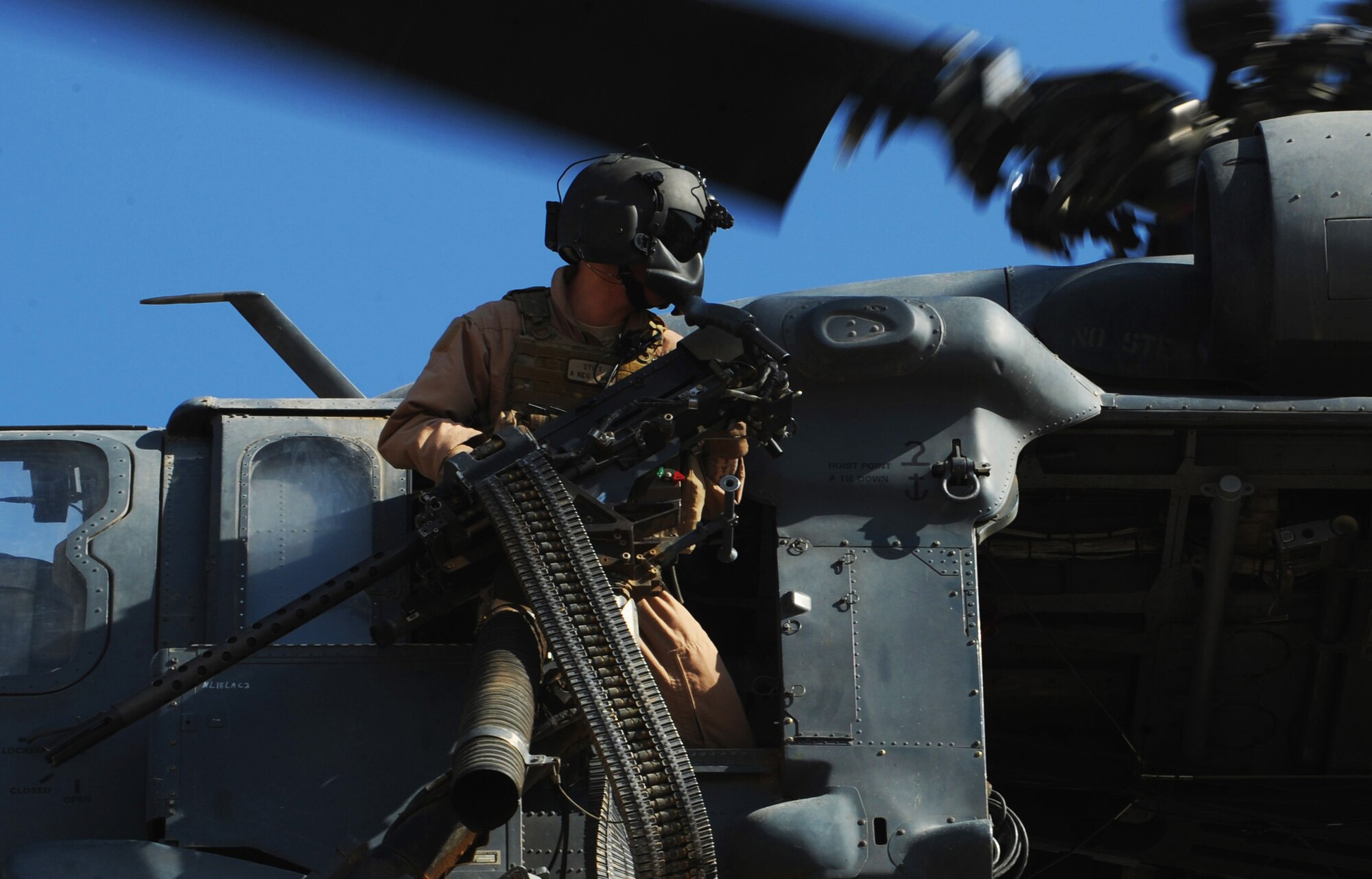 U.S. Air Force HH-60 Pavehawk gunner Staff Sgt. Jason Stitt, 64th Expeditionary Rescue Squadron, Joint Base Balad, Iraq, scans for obstructions during proficiency training outside of Baghdad, Iraq, April 10, 2009, in support of Operation Iraqi Freedom.  (U.S. Air Force photo by Staff Sgt. James L. Harper Jr.)Released