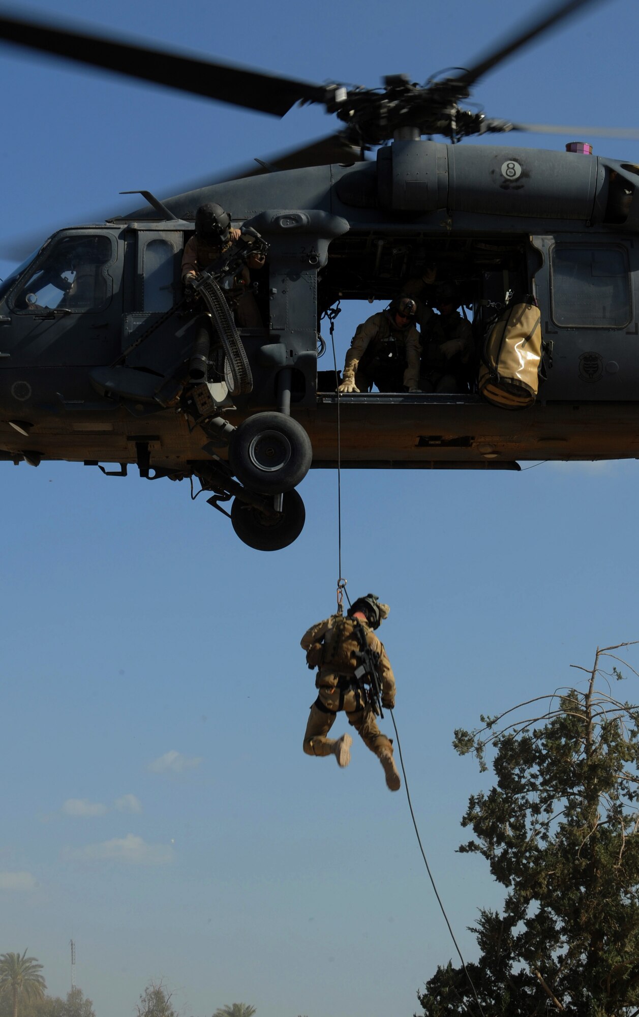 A U.S. Air Force Pararescueman from the 64th Expeditionary Rescue Squadron, Joint Base Balad, Iraq, repels from an HH-60 Pavehawk helicopter during proficiency training outside of Baghdad, Iraq, April 10, 2009, in support of Operation Iraqi Freedom.  (U.S. Air Force photo by Staff Sgt. James L. Harper Jr.)