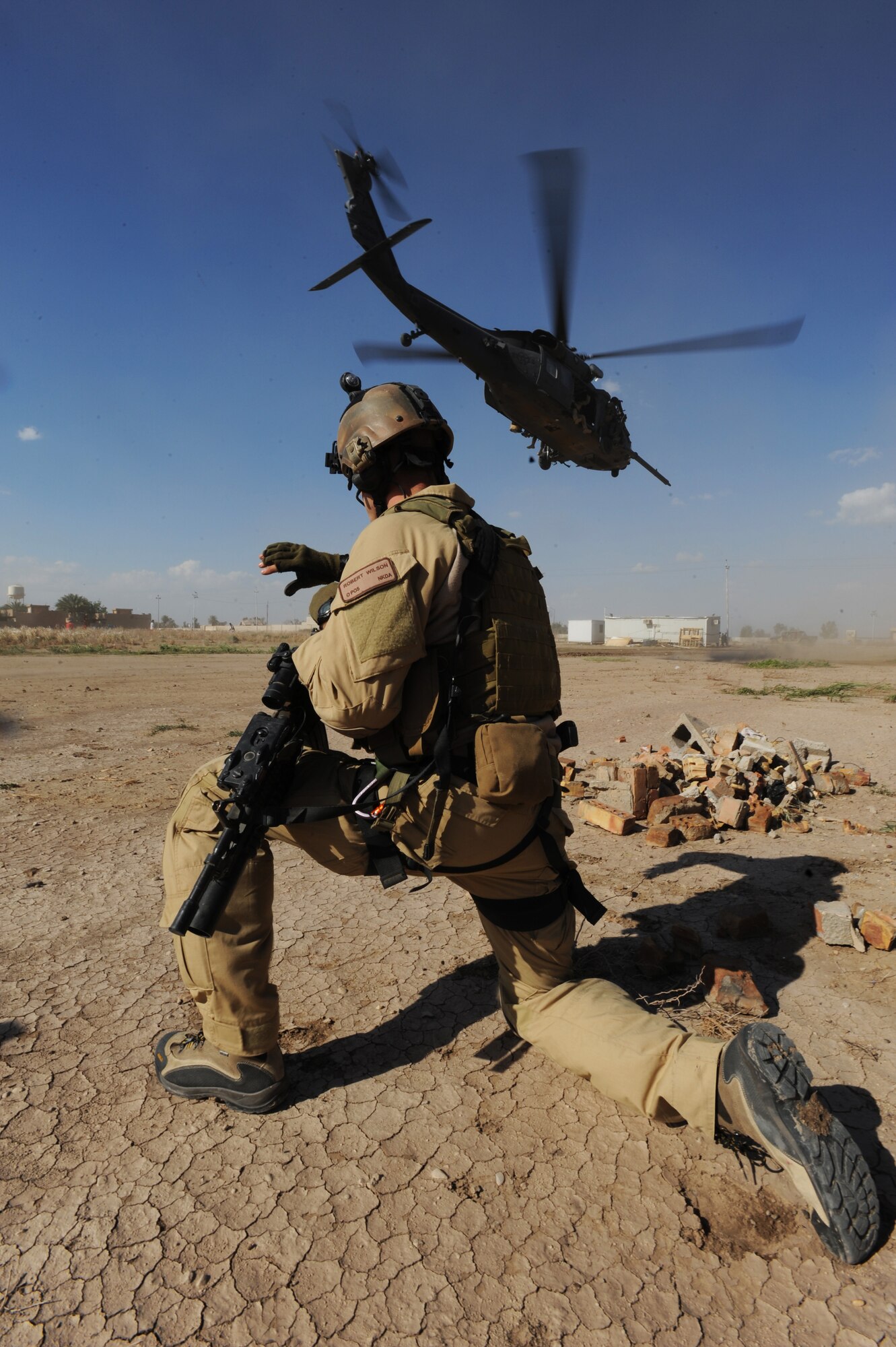 U.S. Air Force Combat Rescue Officer Capt. Robert Wilson, assigned to the 64th Expeditionary Rescue Squadron, Joint Base Balad, Iraq, conducts security for an HH-60 Pavehawk helicopter during proficiency training April 10, 2009, in support of Operation Iraqi Freedom.  (U.S. Air Force photo by Staff Sgt. James L. Harper Jr.)