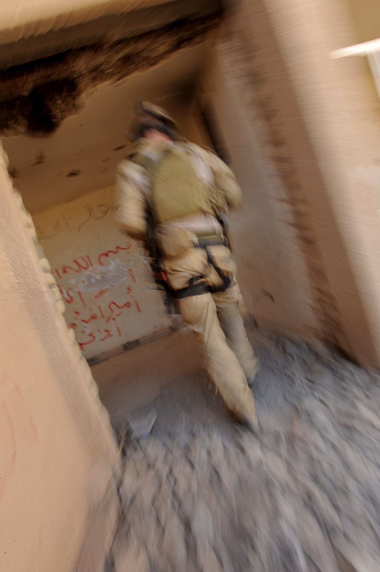 U.S. Air Force Combat Rescue Officer Capt. Robert Wilson, assigned to the 64th Expeditionary Rescue Squadron, Joint Base Balad, Iraq, enters a building during a proficiency exercise April 10, 2009, in support of Operation Iraqi Freedom.  (U.S. Air Force photo by Staff Sgt. James L. Harper Jr.)