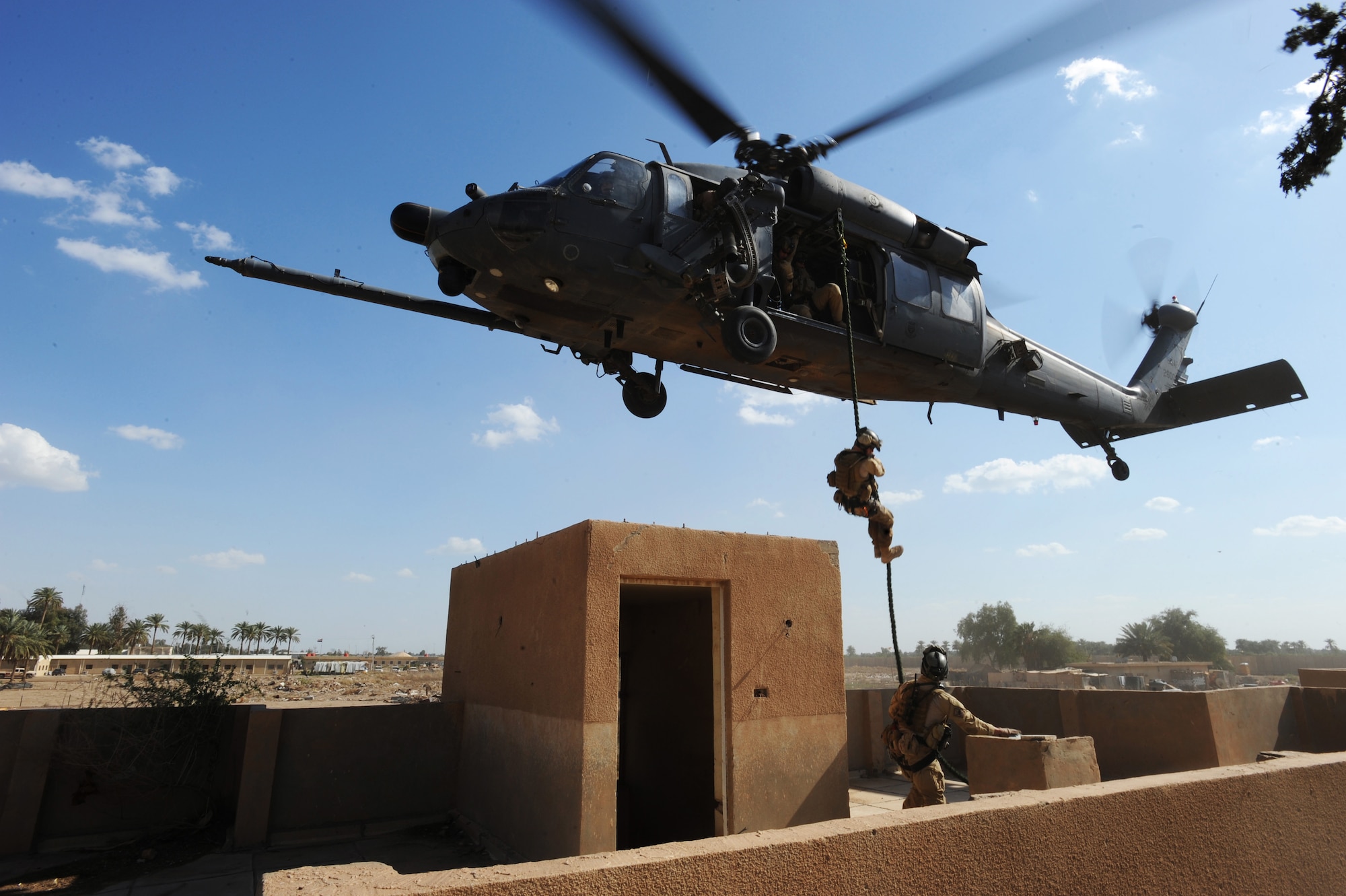 A U.S. Air Force Pararescuemen from the 64th Expeditionary Rescue Squadron, Joint Base Balad, Iraq, fast ropes from an HH-60 Pavehawk helicopter during a proficiency exercise outside of Baghdad, Iraq, April 10, 2009, in support of Operation Iraqi Freedom.  (U.S. Air Force photo by Staff Sgt. James L. Harper Jr.)