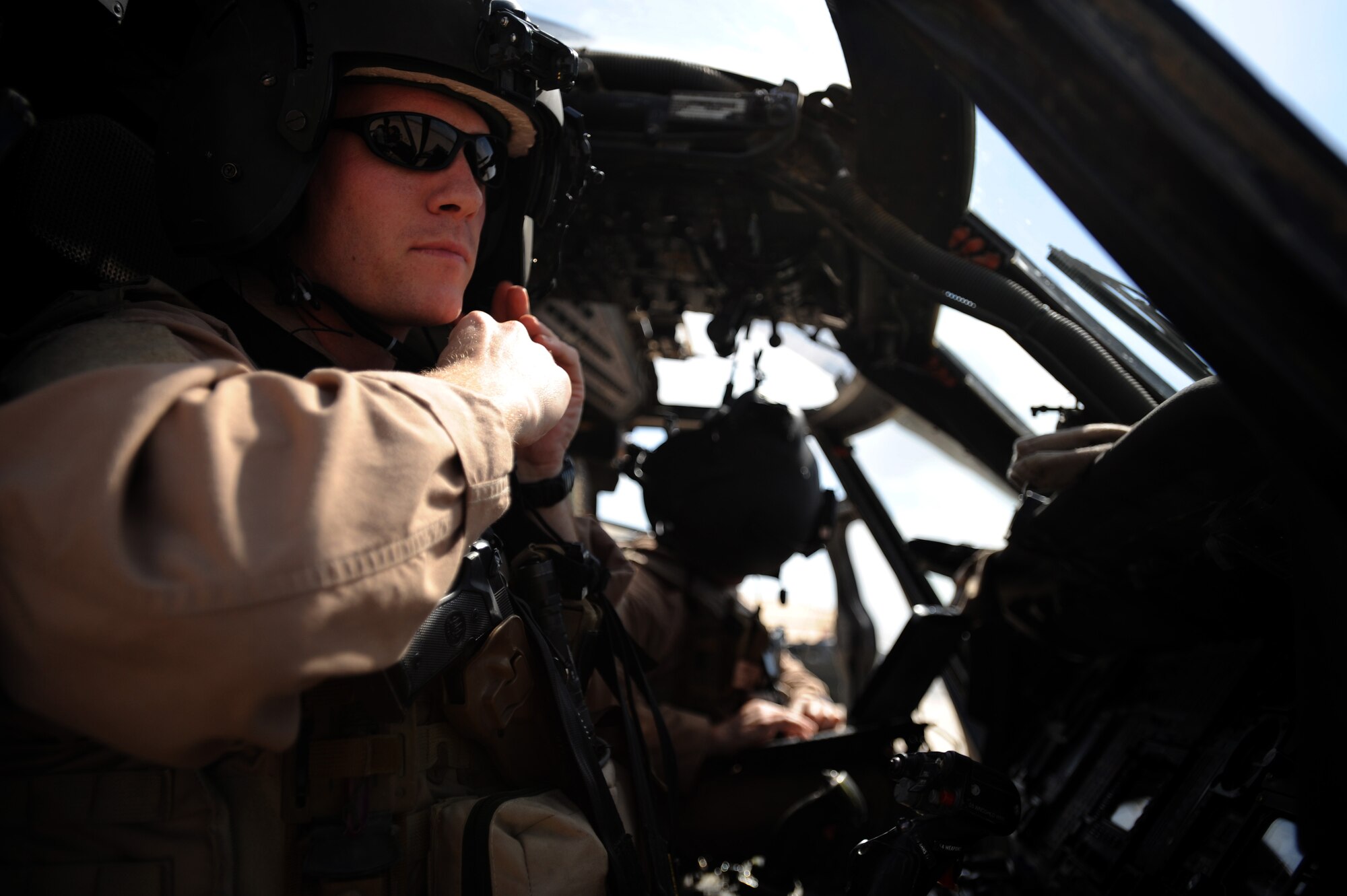 U.S. Air Force Captain Jay Humphrey, HH-60G Pavehawk helicopter pilot assigned to the 64th Expeditionary Rescue Squadron, Joint Base Balad, Iraq, attaches his helmet prior to a proficiency exercise April 10, 2009, in support of Operation Iraqi Freedom.  (U.S. Air Force photo by Staff Sgt. James L. Harper Jr.)
