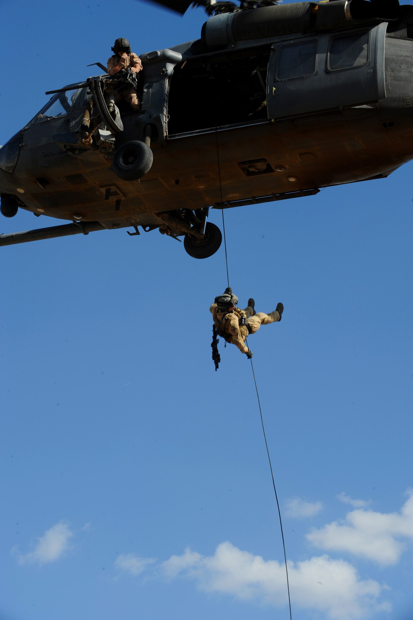 A U.S. Air Force Pararescueman from the 64th Expeditionary Rescue Squadron, Joint Base Balad, Iraq, repels from an HH-60 Pavehawk helicopter during a proficiency exercise outside of Baghdad, Iraq, April 10, 2009, in support of Operation Iraqi Freedom.  (U.S. Air Force photo by Staff Sgt. James L. Harper Jr.)