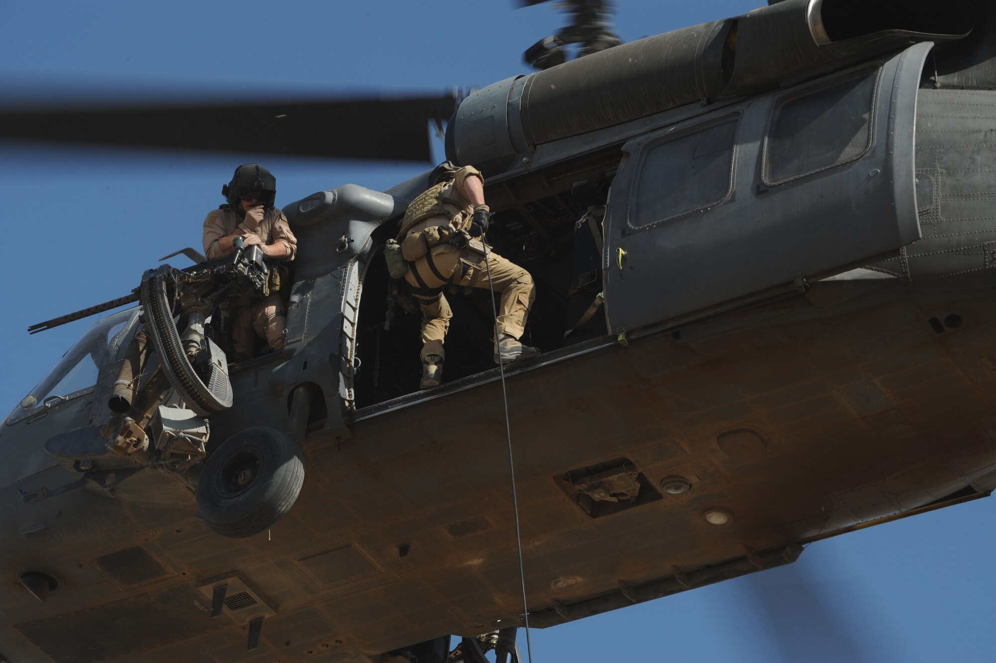 U.S. Air Force Pararescueman Senior Airman Matthew, from the 64th Expeditionary Rescue Squadron, Joint Base Balad, Iraq, prepares to repel from an HH-60 Pavehawk helicopter during a proficiency exercise outside of Baghdad, Iraq, April 10, 2009, in support of Operation Iraqi Freedom.  (U.S. Air Force photo by Staff Sgt. James L. Harper Jr.)