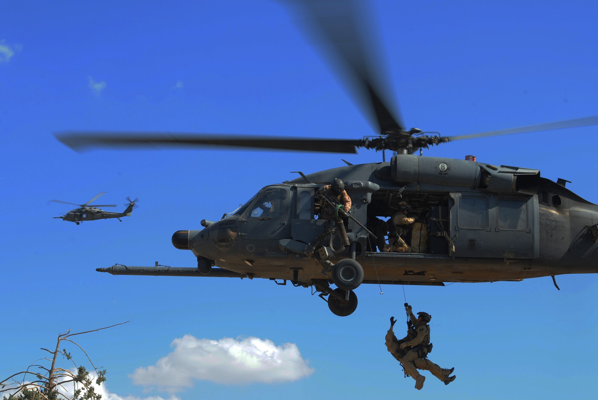 U.S. Air Force Pararescuemen from the 64th Expeditionary Rescue Squadron, Joint Base Balad, Iraq, are hoisted into an HH-60 Pavehawk helicopter outside of Baghdad, Iraq, during a proficiency exercise April 10, 2009, in support of Operation Iraqi Freedom.  (U.S. Air Force photo by Staff Sgt. James L. Harper Jr.)