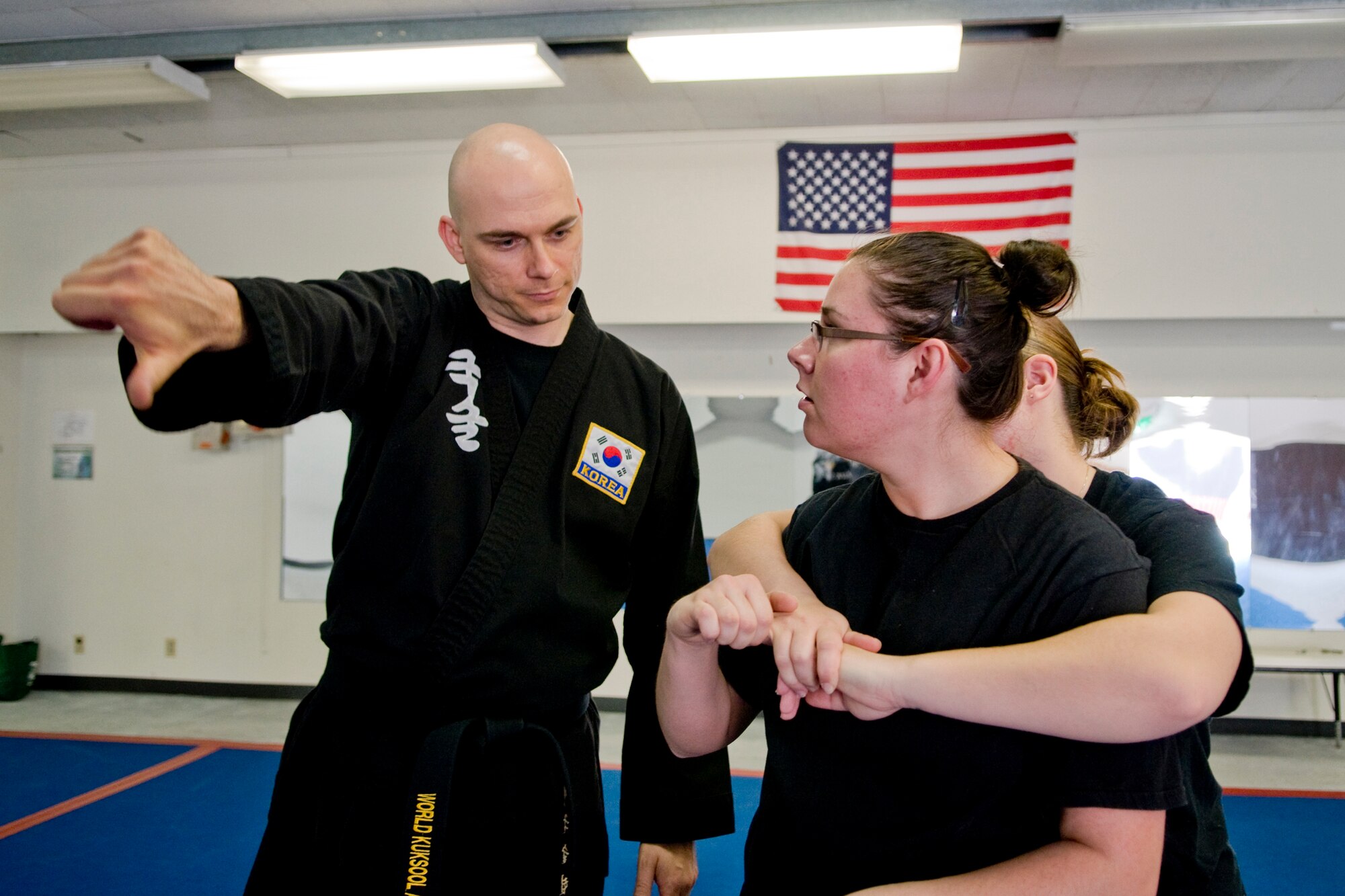 MISAWA AIR BASE, Japan -- Master Sgt. Jeremy Fuegi shows Staff Sgt. Tatum Ramos how to escape from Airman 1st Class Nicole Mangione's hold during a women's self-defense class April 16, 2009. All three Airmen are from the 35th Maintenance Squadron.  (U.S. Air Force photo by Senior Airman Jamal D. Sutter)