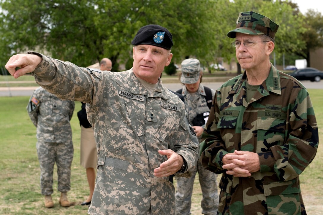 U.S. Army Maj. Gen. Jeffery W. Hammond, commanding general of the 4th Infantry Division, points out aspects of a new memorial to U.S. Navy Adm. Mike Mullen, chairman of the Joint Chiefs of Staff, Fort Hood, Texas, April 16, 2009. The memorial honors the 4th Infantry Division's Task Force Ironhorse soldiers who were killed during Operation Iraqi Freedom.