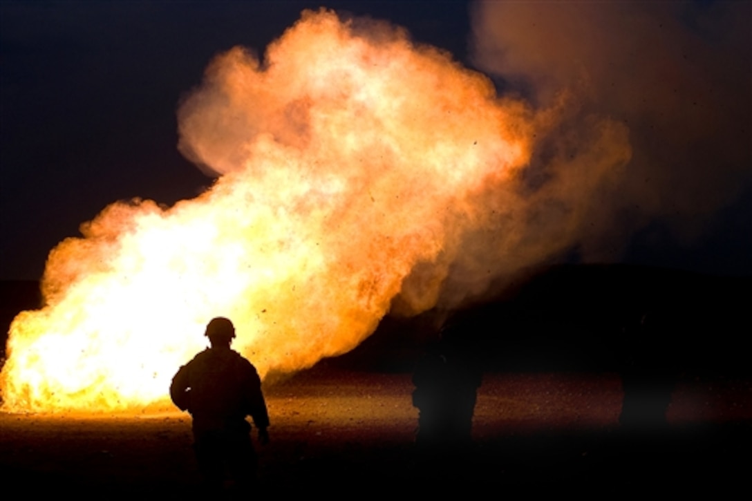 U.S. Army Staff Sgt. Alexis Castillo watches as unused mortar 'cheese' charges are disposed by fire during a mortar training exercise with Iraqi soldiers on Saber Range outside Mansurya village in Diyala province, Iraq, April 4, 2009. Castillo is assigned to the 1st Calvary Division's Headquarters Company, 8th Calvary Regiment, 2nd Brigade Combat Team.