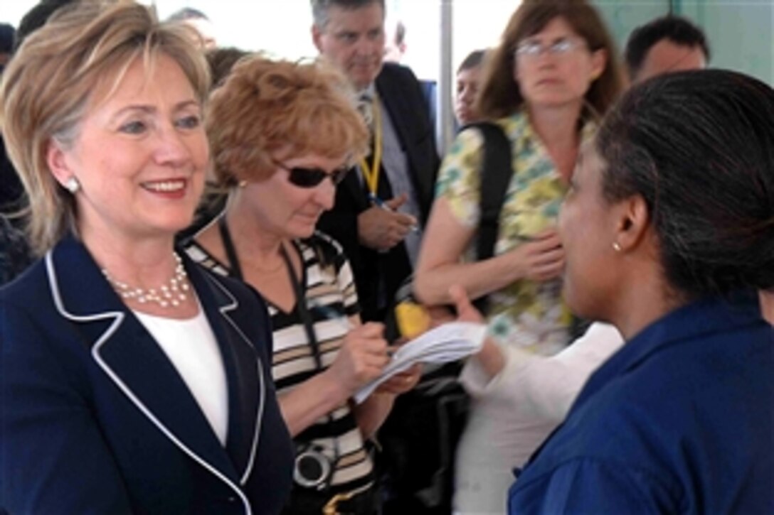 Secretary of State Hillary Rodham Clinton greets Navy Lt. Patricia Gill in Cite Soleil, Haiti, April 16, 2009. Clinton visited Cite Soleil to observe the humanitarian and civic assistance provided to the Haitian people by the hospital ship USNS Comfort in support of Continuing Promise 2009.