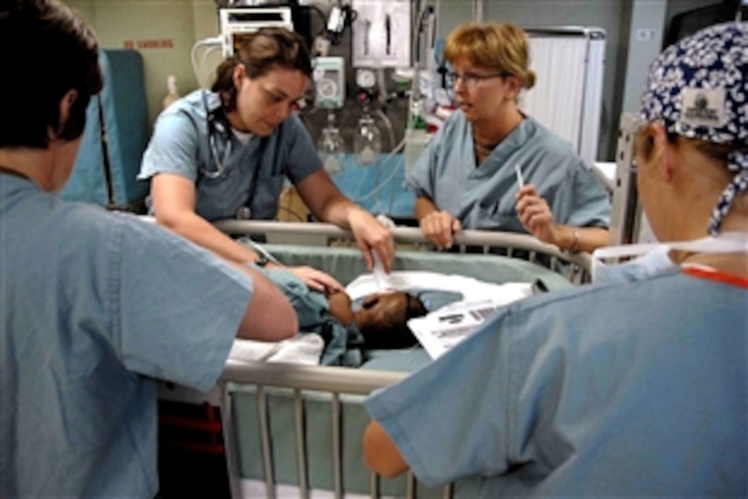 U.S. Navy Ensign Kathleen Kostka checks Neritza Dor's vital signs after undergoing surgery, April 12, 2009. Neritza was the first patient to be brought aboard the hospital ship USNS Comfort during its Continuing Promise 2009 mission.
