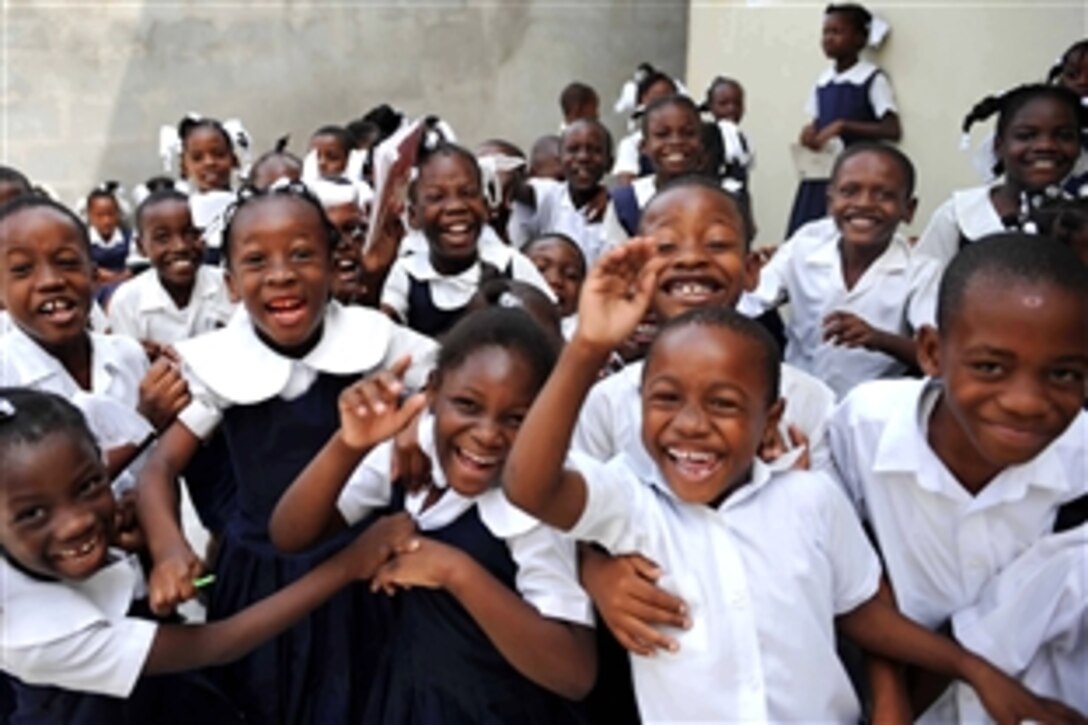 Haitian students from Emmanuel Christian School pose for a photo during a Continuing Promise 2009 community service project. Servicemembers aboard the military hospital ship USNS Comfort visited the school to paint the walls of a pediatric medical facility in Port au Prince, April 16, 2009.