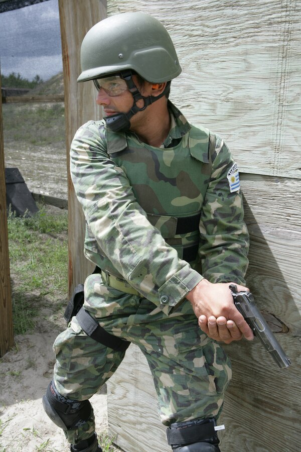 A Marine from Uruguay prepares to perform a room clearing technique during Partnership of the Americas (POA) 2009. POA, which is being executed simultaneously with UNITAS Gold, is an annual U.S. Marine Corps Forces, South multi-national company-level combined and joint exercise that focuses on enhancing interoperability between U.S. Marines and partner-nation Marines in the areas of amphibious operations, non-combatant evacuation operations (NEO), peacekeeping and disaster relief.  Deployed as Special Purpose Marine Air Ground Task Force 24 (SPMAGTF 24), the U.S. Marines of 24th Marine Regiment, 4th Marine Division, are conducting training with Marines from Brazil, Chile, Colombia, Mexico, Peru, Uruguay, and soldiers from the Royal Canadian Army.