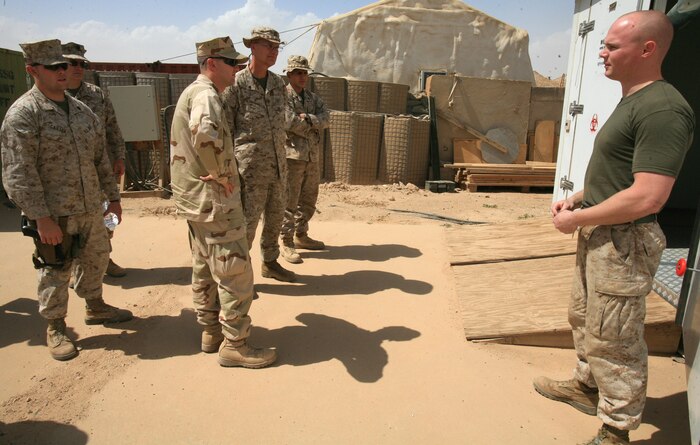 Sgt Gerard B. Lane, 2nd Marine Logistics Group (Forward) mortuary affairs, gives 2nd MLG (Fwd) unit chaplains a tour of the Personnel Retrieval and Processing facility at Camp Al Taqaddum, Iraq, April 18, 2009.  The tour was part of a conference held by Cmdr. Douglas M. Withington, 2nd MLG (Fwd) chaplain, to familiarize small unit chaplains with the command staff’s expectations. (U.S. Marine Corps photograph by LANCE CPL. MELISSA A. LATTY)