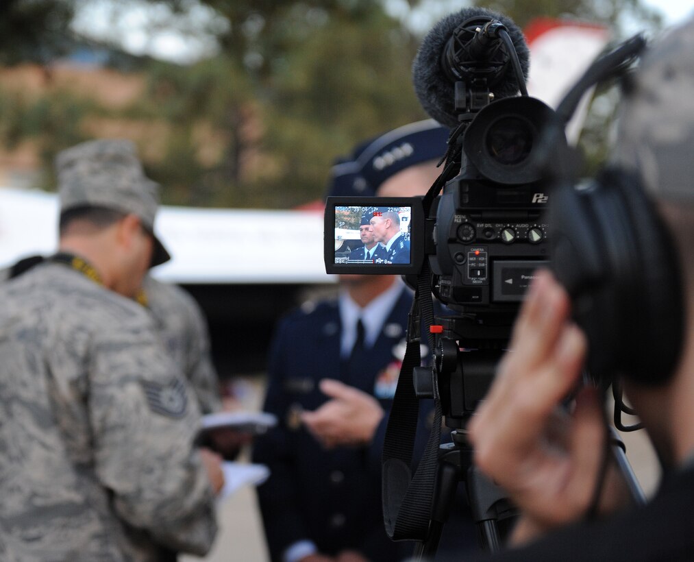 LANGLEY AIR FORCE BASE, Va. -- Tech. Sgt. Matthew McGovern, personnel from Defense Media Activity, interviews Gen. John D. W. Corely, Air Combat Command commander and Brig. Gen. Mark A. Barrett, 1st Fighter Wing commander, during the opening ceremony of Air Force Week at Hampton University April 18.  The ceremony kicked off a week of activities that will allow the community an opportunity to meet Air Force members, see how they help protect America, and allow them to say "thank you" for their support. (U.S. Air Force photo/Airman 1st Class Zachary Wolf) 