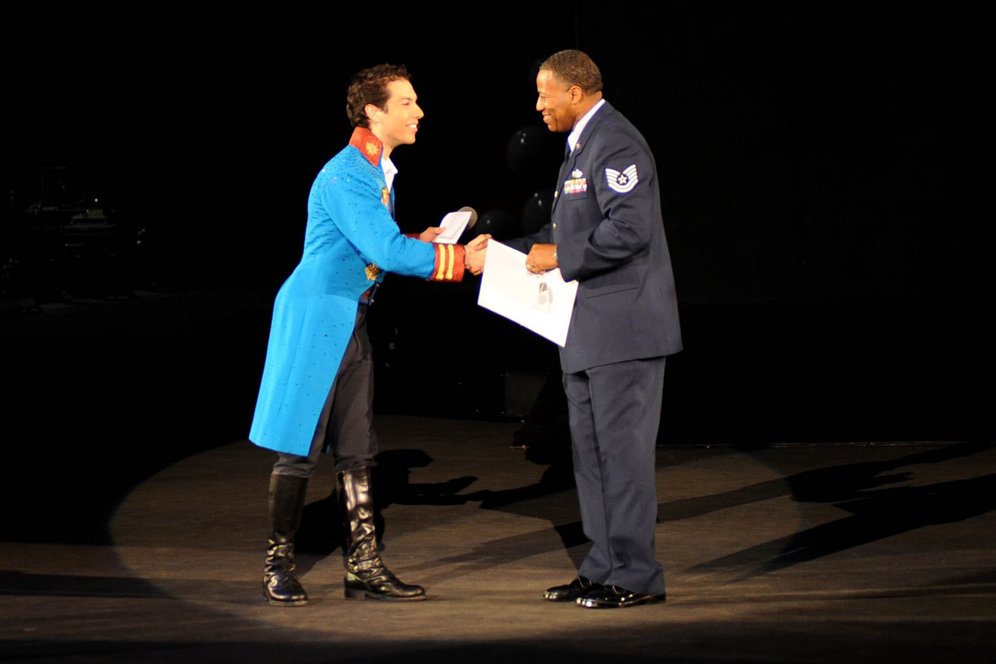 LANGLEY AIR FORCE BASE, Va.-- Alex Ramon, the ringmaster for Ringling Bros. and Barnum & Bailey's new show, "Zing Zang Zoom!" presents the guest ringmaster, Tech. Sgt. Derek Johnson, 497th Intelligence, Surveillance, and Reconnaissance Group, with a certificate of participation at the Norfolk Scope April 18. Sergeant Johnson was chosen to be the guest ringmaster after recently returning from a deployment supporting both U.S. and coalition forces. (U.S. Air Force photo/Airman Rebecca Montez)