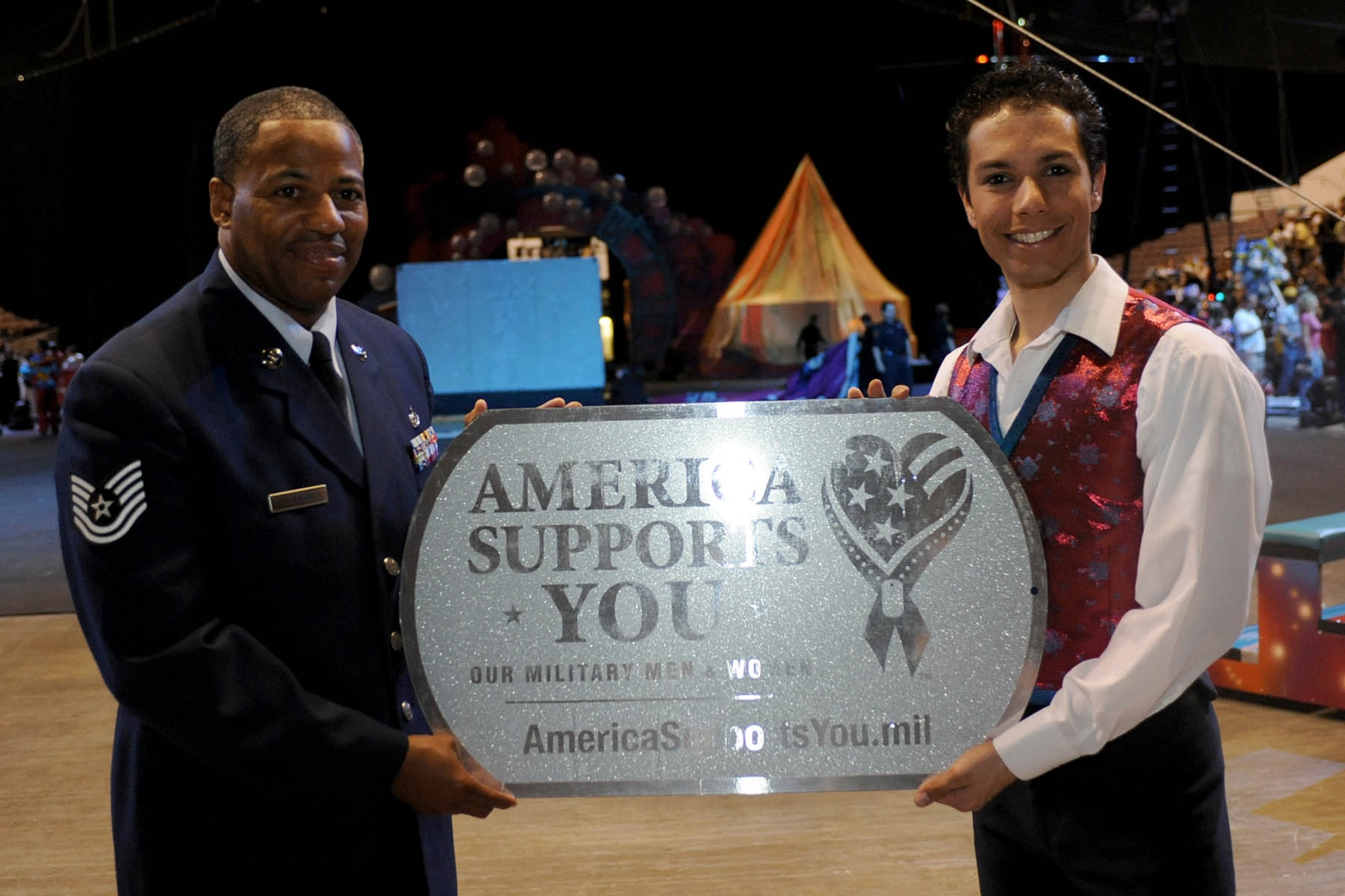 LANGLEY AIR FORCE BASE, Va.-- Tech. Sgt. Derek Johnson, 497th Intelligence, Surveillance, and Reconnaissance Group, poses with Alex Ramon, the ringmaster for Ringling Bros. and Barnum & Bailey's new show, "Zing Zang Zoom!" at the Norfolk Scope, April 18. Sergeant Johnson was chosen to be the guest ringmaster after recently returning from a deployment supporting both U.S. and coalition forces. (U.S. Air Force photo/Airman Rebecca Montez)