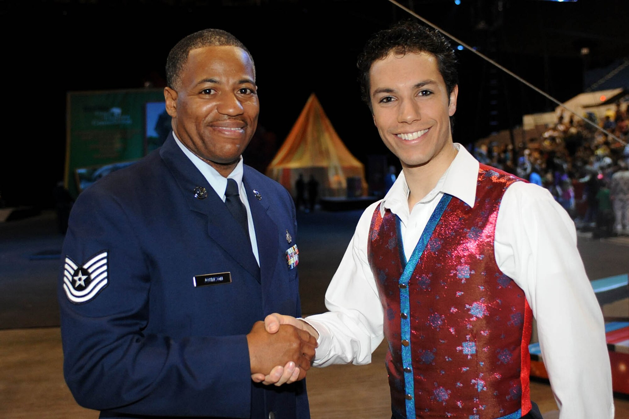 LANGLEY AIR FORCE BASE, Va.-- Tech. Sgt. Derek Johnson, 497th Intelligence, Surveillance, and Reconnaissance Group, shakes hands with Alex Ramon, the ringmaster for Ringling Bros. and Barnum & Bailey's new show, "Zing Zang Zoom!" at the Norfolk Scope April 18.  Sergeant Johnson was chosen to be the guest ringmaster after recently returning from a deployment supporting both U.S. and coalition forces. (U.S. Air Force photo/Airman Rebecca Montez)