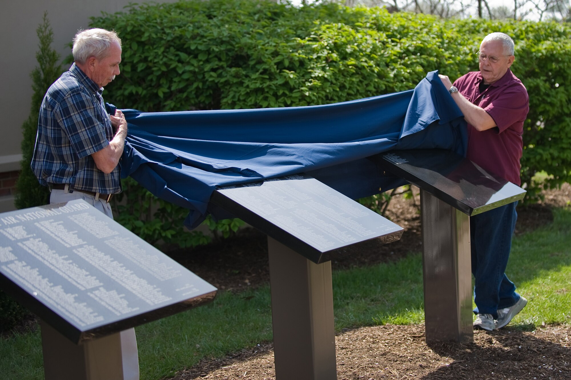 Chief Master Sgt. Jim Turpin (Ret.) and Col. Ed Horung (Ret.) unveil plaques that hold the names of Kentucky Air National Guard retirees from 2007 and 2008 at a ceremony held at the Kentucky Air Guard April 18. (USAF Photo by Capt. Dale Greer.)