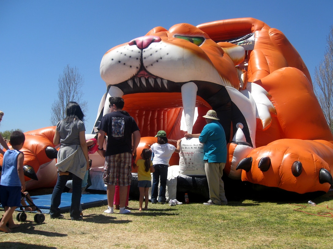 Families line up to jump in a bounce house during the jungle-themed Spring Carnival on Camp Pendleton, April 18. Lincoln Military Housing hosted the annual event that included face paintings, rock walls and an live animal show.