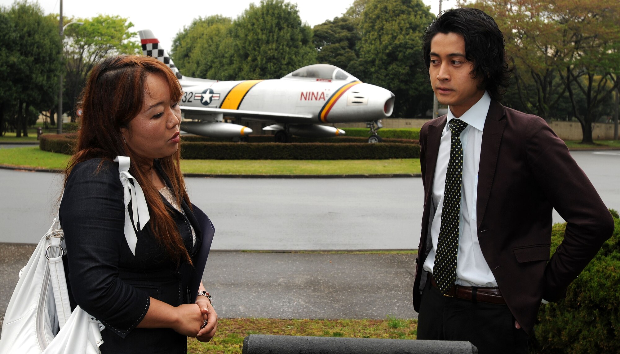 YOKOTA AIR BASE, Japan -- Mieko Morita, 374th Airlift Wing Public Affairs office, (left) escorts Takayuki Hakamada, a reporter with the Mainichi Shimbun, around base April 17 on an orientation tour. The Mainichi Shimbun is one of five national newspapers in Japan and has a daily circulation of nearly 4 million papers. The wing public affairs office takes a proactive approach to the base's relationship with local and internal media representatives. Members of Team Yokota should contact the public affairs office before inviting media to the base or speaking to the media in an official capacity. (U.S. Air Force photo/Airman 1st Class Michael Dillon) 