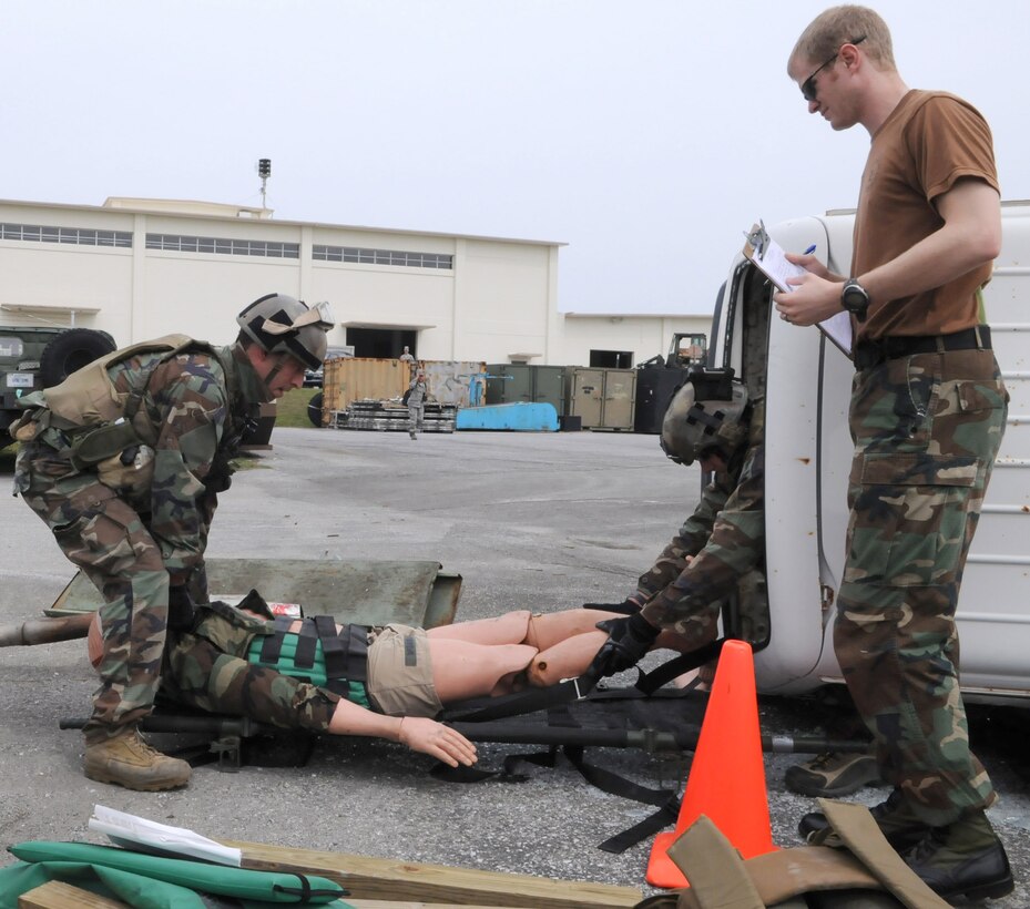 KADENA AIR BASE, Japan -- Pararescuemen from the 320th Special Tactics Squadron pull a simulated patient from a vehicle as an evaluator looks on during a training exercise here April 16. Pararescuemen are the only Department of Defense specialty specifically trained and equipped to conduct conventional or unconventional rescue operations. These battlefield Airmen are personnel recovery specialists with emergency medical capabilities able to locate and save injured personnel anytime, anywhere. (Photo by Tech. Sgt. Aaron Cram)