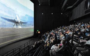 LANGLEY AIR FORCE BASE, Va. -- Military and civilian personnel enjoy the free IMAX movie "Fighter Pilot: Operation Red Flag" at the Virginia Air and Space Center April 19. Hampton Roads Air Force Week offers free admission to the center and movie through April 23 for the public. (U.S. Air Force photo/Airman Rebecca Montez)