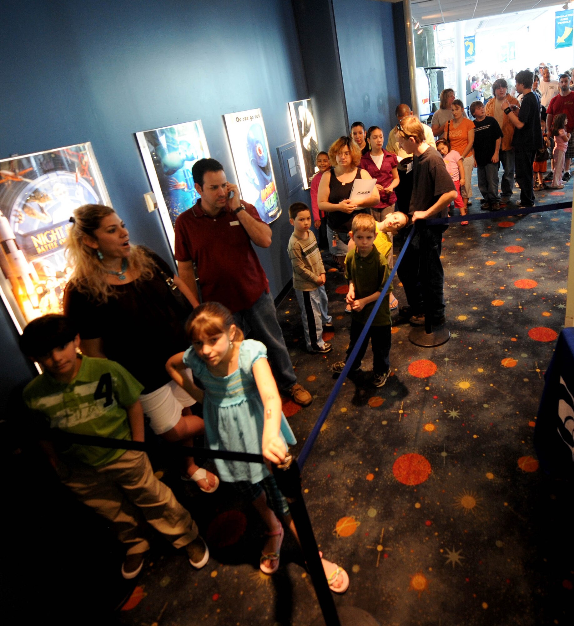 LANGLEY AIR FORCE BASE, Va. -- People line up to experience the free IMAX movie "Fighter Pilot: Operation Red Flag" at the Virginia Air & Space Center exhibits during Hampton Roads Air Force Week April 19.  In addition to the IMAX movie, this event offered free admission to the center, Air Force Recruiting Service “Inspire Tour” Displays, and Langley AFB unit displays (U.S. Air Force photo/Airman Rebecca Montez)