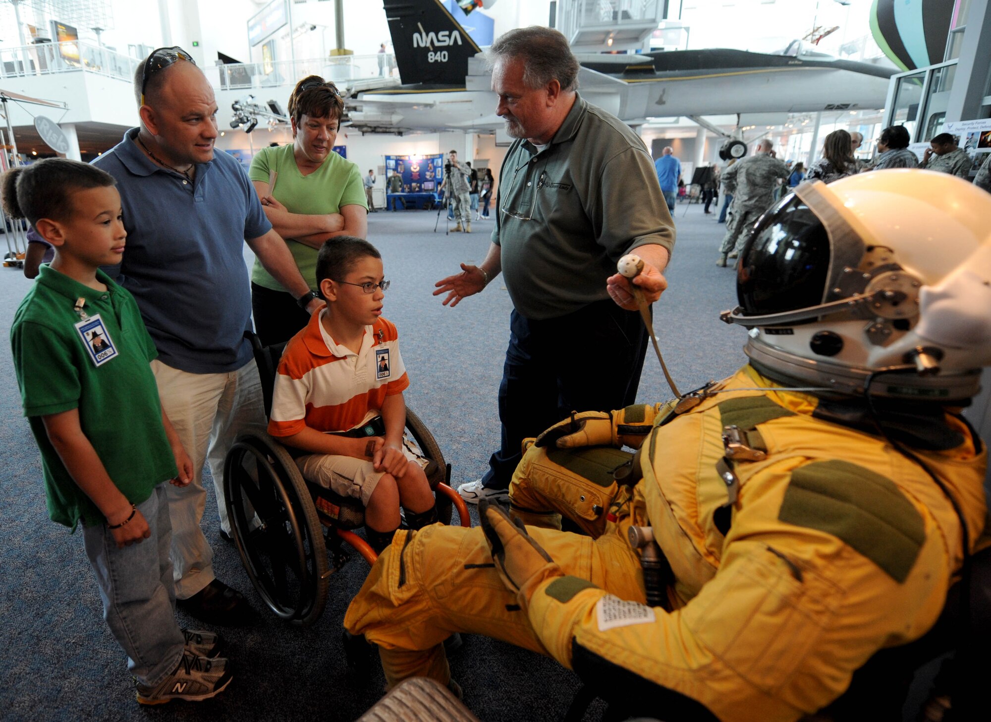 LANGLEY AIR FORCE BASE, Va. -- James Bullard, a logistic integration support engineer with the U-2 Spy Plane "Dragon Lady" explains parts of the pilot's astronaut suit to the Retzlaff family at the Virginia Air & Space Center during Hampton Roads Air Force Week April 19.  This event offered free admission to center, free IMAX movie “Fighter Pilot: Operation Red Flag,” Air Force Recruiting Service “Inspire Tour” displays, and Langley AFB unit displays. (U.S. Air Force photo/Airman Rebecca Montez)