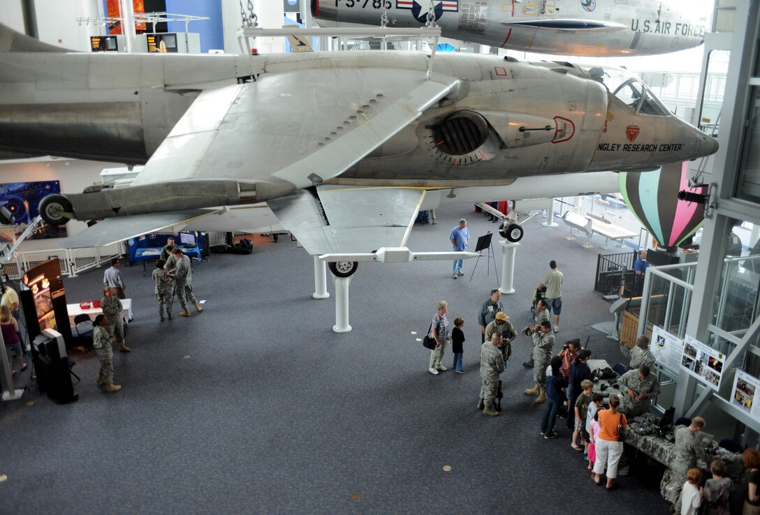 LANGLEY AIR FORCE BASE, Va. -- Vistors meet with Air Force personnel at the Virginia Air & Space Center exhibits during Hampton Roads Air Force Week April 19. This event offered free admission to center, free IMAX movie “Fighter Pilot: Operation Red Flag,” Air Force Recruiting Service “Inspire Tour” Displays, and Langley AFB unit displays. (U.S. Air Force photo/Airman Rebecca Montez)