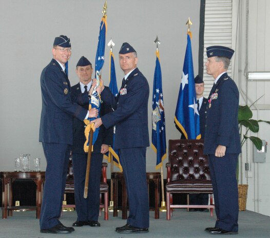 Major General James Rubeor, commander of the 22nd Air Force, passes the wing flag to Col. Steven Chapman, the new commander of the 315th Airlift Wing, during the Change of Command Ceremony April 19. (U.S. Air Force photo by Senior Airman Dani Pacheco)