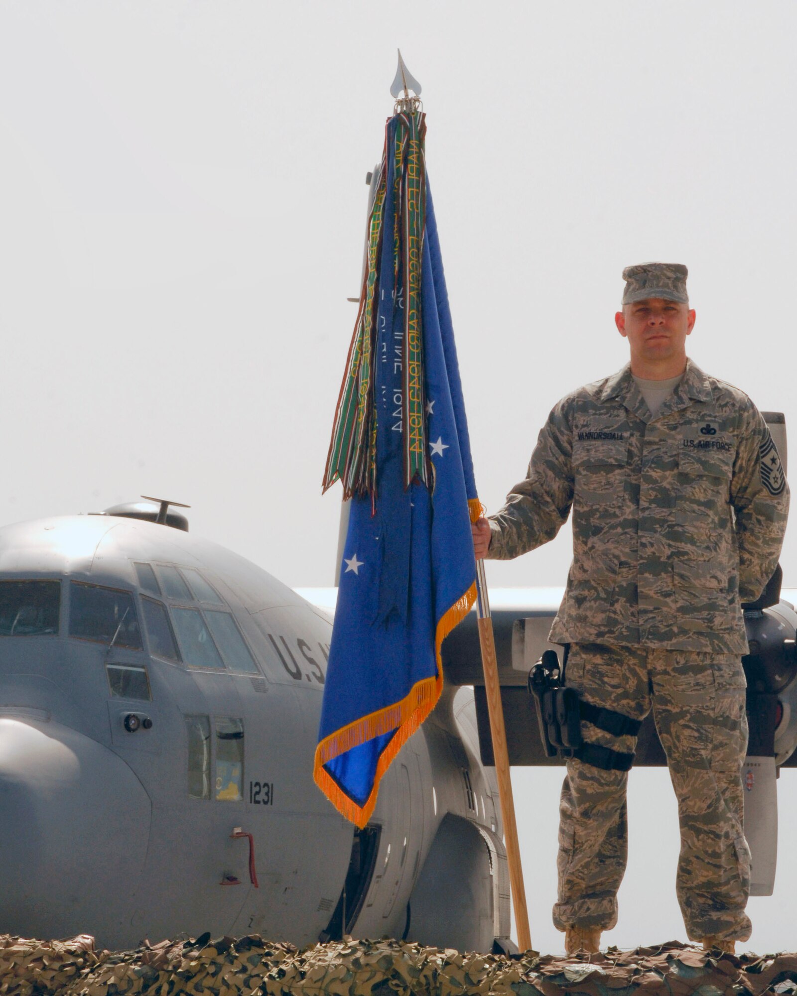 Chief Master Sgt. Dennis Vannorsdall, 455th Air Expeditionary Wing Command Chief, stands with the wing guidon during the Change of Command ceremony at Bagram Air Field, Afghanistan, April 18. (U.S. Air Force photo/Senior Airman Erik Cardenas)(Released)