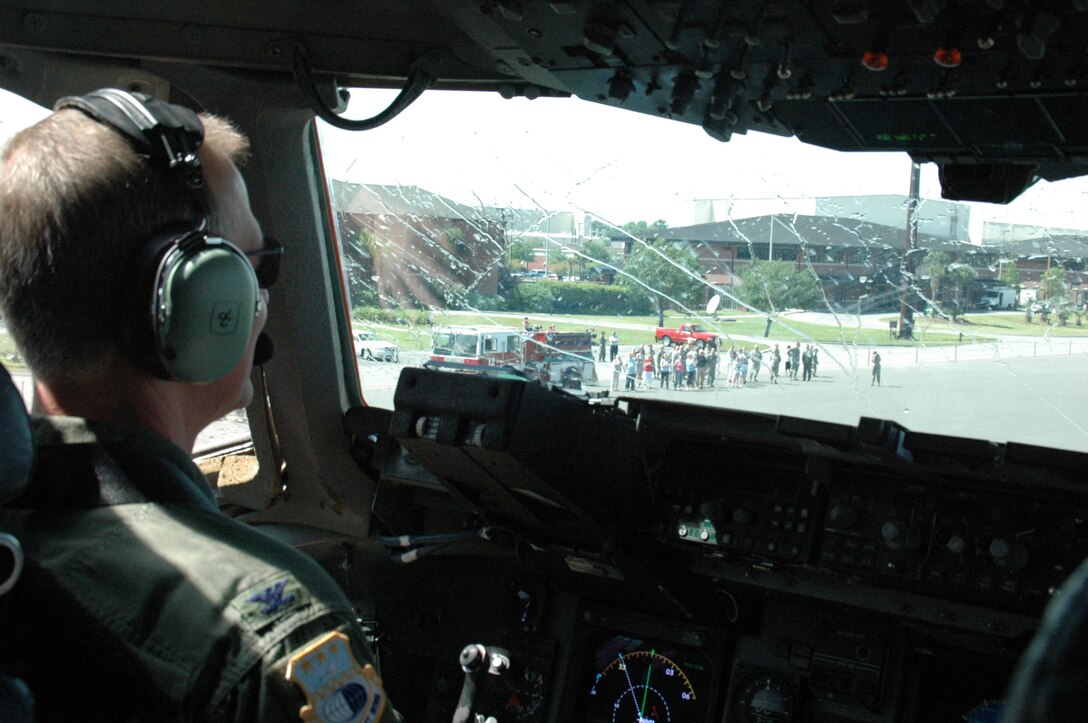 Col. Tim Wrighton, commander of the 315th Airlift Wing here at Charleston Air Force Base, looks out at his friends, family and fellow reservissts from the pilot seat of a C-17 following his "Fini Flight" April 18. Col. Wrighton is scheduled to relinquish command of the 315th Airlift Wing in an official ceremony at Charleston Air Force Base April 19. 