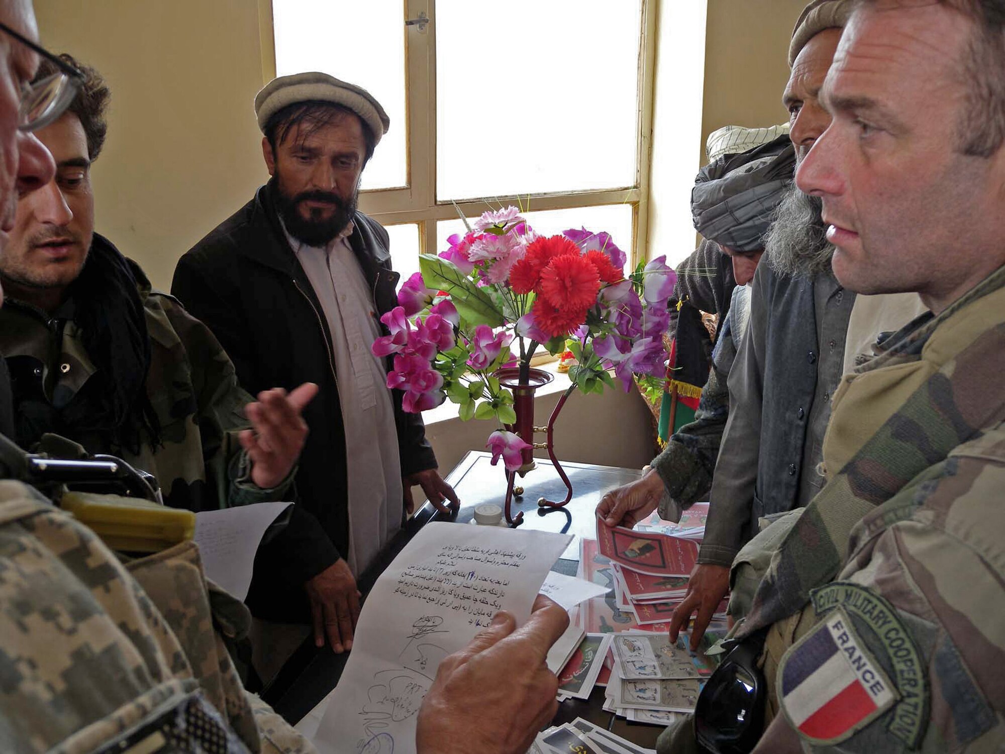 French and U.S. military representatives speak with local village elders in the Alasay Valley. A Joint Civilian Military Cooperation and Provincial Reconstruction Team met with students and teachers from two schools in the village to determine the needs of the community. (French Army photo by Maj. Patrick Simo)                               