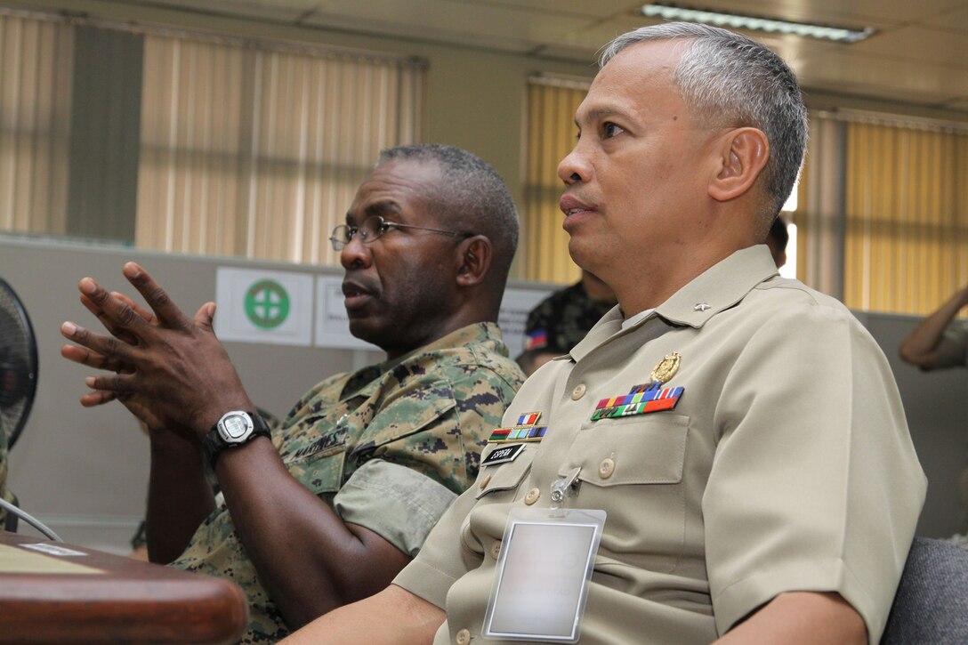 Brigadier Gen. Ronald L. Bailey (left), co-director, Balikatan ’09, and AFP Commodore Ramon P. Espera Jr., RP Balikatan ’09 exercise director, listen attentively during the first bilateral Balikatan 2009 commander’s brief at the Command and General Staff College here April 20. Photo by Lance Cpl. Cristina Gil