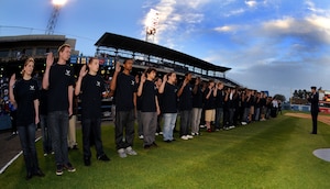 LANGLEY AIR FORCE BASE, Va. -- Maj. Gen. Frank Gorenc, Air Combat Command air and space operations directorate, administers the oath of enlistment to the 45 Air Force Delayed Entry Program participants from the Hampton Roads area at the Norfolk Tides baseball season opener April 20 during Air Force Week.  AF Week is the Air Force's chance to thank those who support the military through a variety of events.   (U.S. Air Force photo/Senior Airman Scott Aldridge)