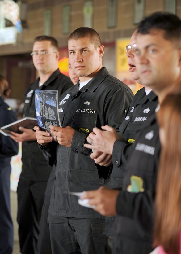 LANGLEY AIR FORCE BASE, Va. -- F-22 Raptor Aerial Demonstration Team members hand out flyers and pamphlets during Air Force Night at the Norfolk Tides baseball season opener April 20.  The flyers and pamphlets contained information about the F-22 Raptor to broaden the public's knowledge of its mission during Air Force Week. AF Week is the Air Force's chance to thank those who support the military through a variety of events.  (U.S. Air Force photo/Airman 1st Class Jonathan Koob)