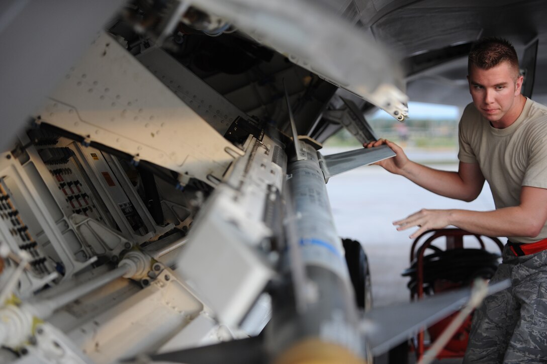 Airman 1st Class Daniel Kok, 36th Expeditionary Maintenance Squadron weapons loader, conducts an F-22 Raptor preflight inspection at Andersen Air Force Base, Guam April 15. The 90th Fighter Squadron from Elmendorf Air Force Base, Alaska just completed a 3-month deployment to Andersen as part of a theater security package. The U.S. Pacific Command is committed to providing an environment of security, and stability to support and foster freedom and prosperity throughout the region. (U.S. Air Force photo/ Master Sgt. Kevin J. Gruenwald) released