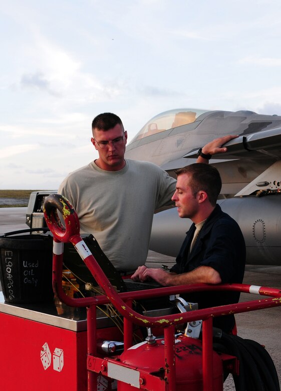Airman 1st Class Michael Biggs and Staff Sgt. Chad Konyndyk, 36th Expeditionary Maintenance Squadron crew chiefs, conduct a maintenace check on an F-22 Raptor the night before its departure from Andersen Air Force Base, Guam, April 15.  The 90th Expeditionary Fighter Squadrons  90-day deployment to Andersen Air Force Base, Guam, consisiting of more than 250 Airmen and 14 aircraft, came to a close April 16.  the 90th EFS was deployed here via a regularly scheduled Air Expeditionary Force rotation, demonstrating U.S. commitment to peace and stability throughout the Pacific region.(U.S. Air Force photo/Senior Airman Ryan Whitney)