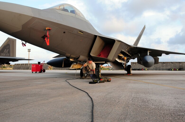 Airman 1st Class Joe Weinert, crew chief with the 36th Expeditionary Aircraft Maintenance Squadron, checks the tire pressure of an F-22 Raptor the night before its departure form Andersen Air Force Base, Guam, April 15. The 90th Expeditionary Fighter Squadrons  90-day deployment to Andersen Air Force Base, Guam, consisiting of more than 250 Airmen and 14 aircraft, came to a close April 16.  the 90th EFS was deployed here via a regularly scheduled Air Expeditionary Force rotation, demonstrating U.S. commitment to peace and stability throughout the Pacific region.(U.S. Air Force photo/Senior Airman Ryan Whitney)