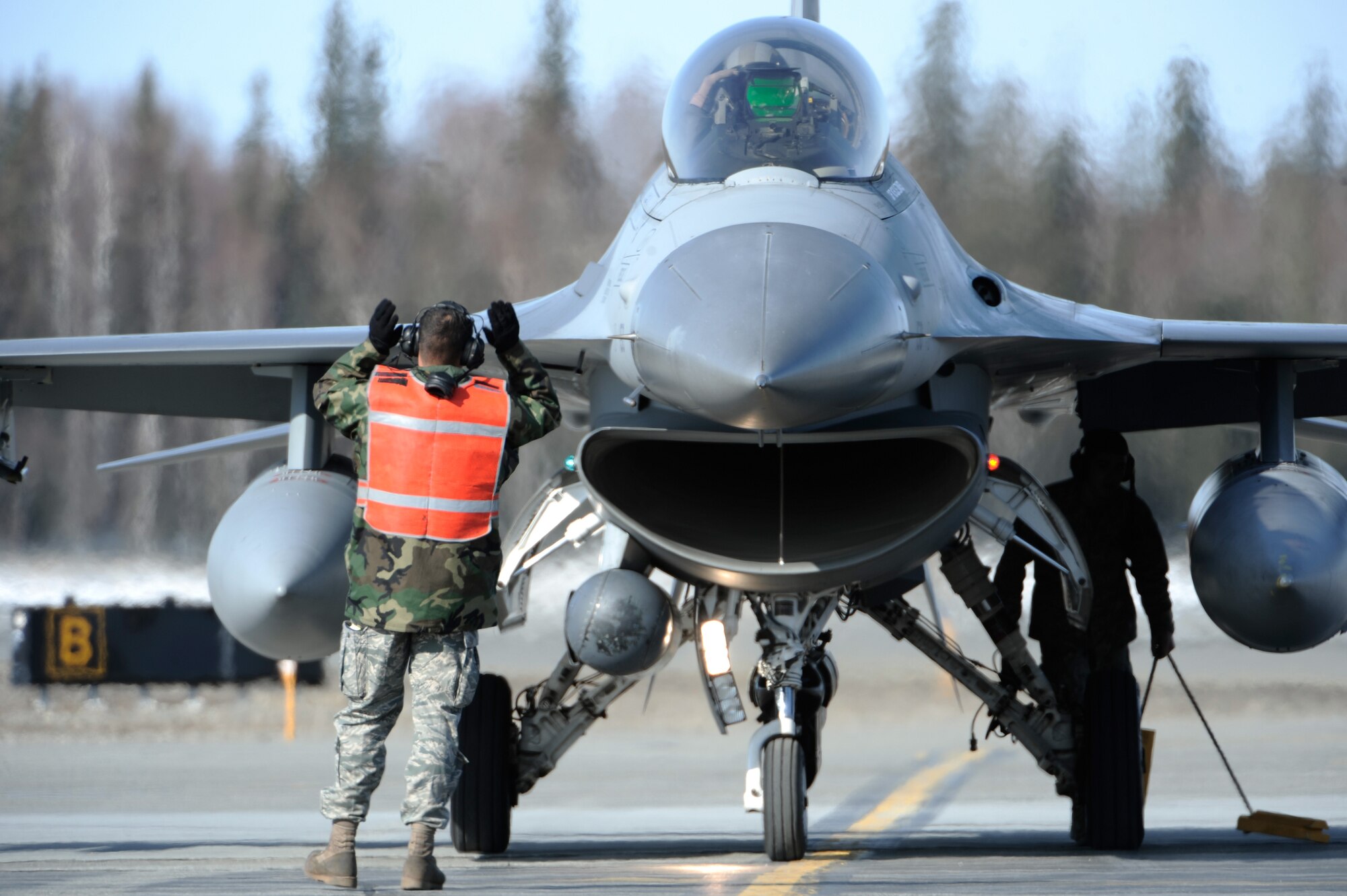 Staff Sgt. Jason Lewey, 8th Aircraft Maintenance Squadron, marshals a F-16 Fighting Falcon, 35th Fighter Squadron, Kunsan Air Base, Korea after returning from a training mission, April 20, 2009, during RED FLAG_Alaska 09-2 at Eielson Air Force Base, Alaska. RF-A provides training for deployed maintenance and support personnel in sustainment of a large-force deployed air operation.  (U.S. Air Force Photo/Senior Airman Jonathan Snyder)