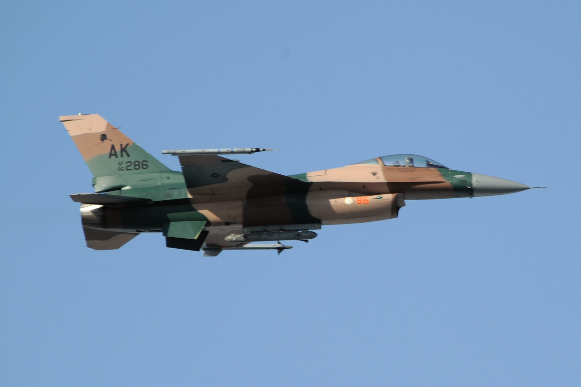 A F-16 Aggressor with the flogger flanker scheme heads towards the Joint Pacific Alaskan Range Complex for a RED FLAG-Alaska training mission, April 20, 2009, Eielson Air Force Base, Alaska. RF-A 09-2 is a Pacific Air Forces command directed field training exercise which provides joint offensive counter-air, interdiction, close air support and large force employment training in a simulated combat environment. The aircraft is assigned to the 18th Aggressor Squadron.  (U.S. Air Force Photo/Senior Airman Jonathan Snyder)