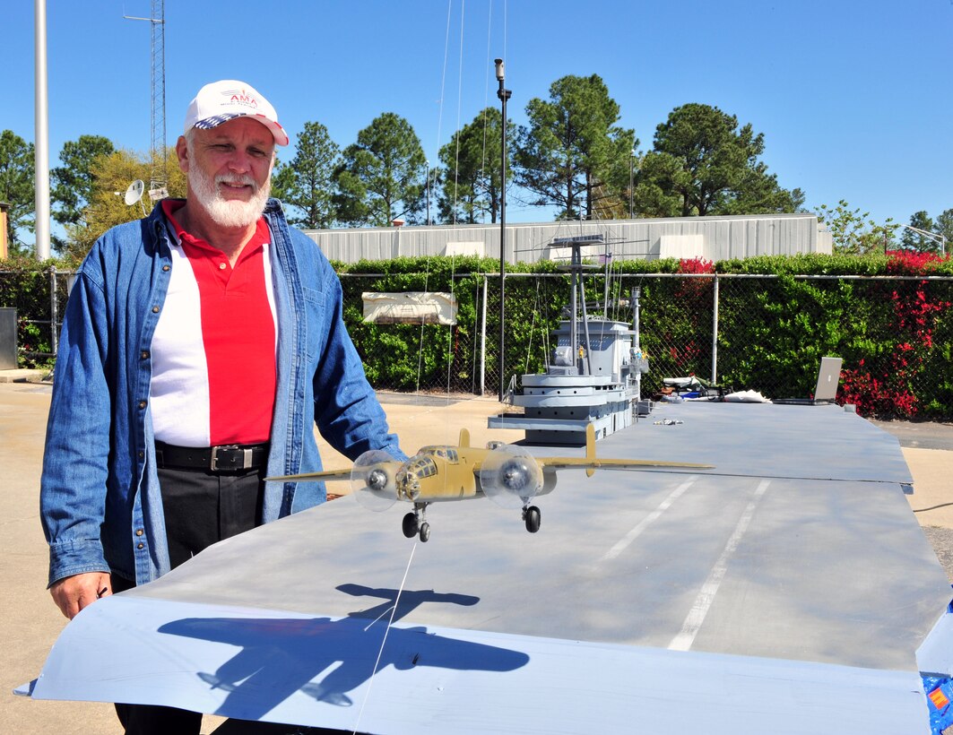 Jerry Branch displays his replica USS Hornet with B-25s launching off the deck during a Doolittle Raider celebration April 17 at Columbia Metro Airport in Columbia, S.C. Mr. Branch built the model in tribute to the Doolittle Raiders. (U.S. Air Force photo/Senior Airman William Coleman)