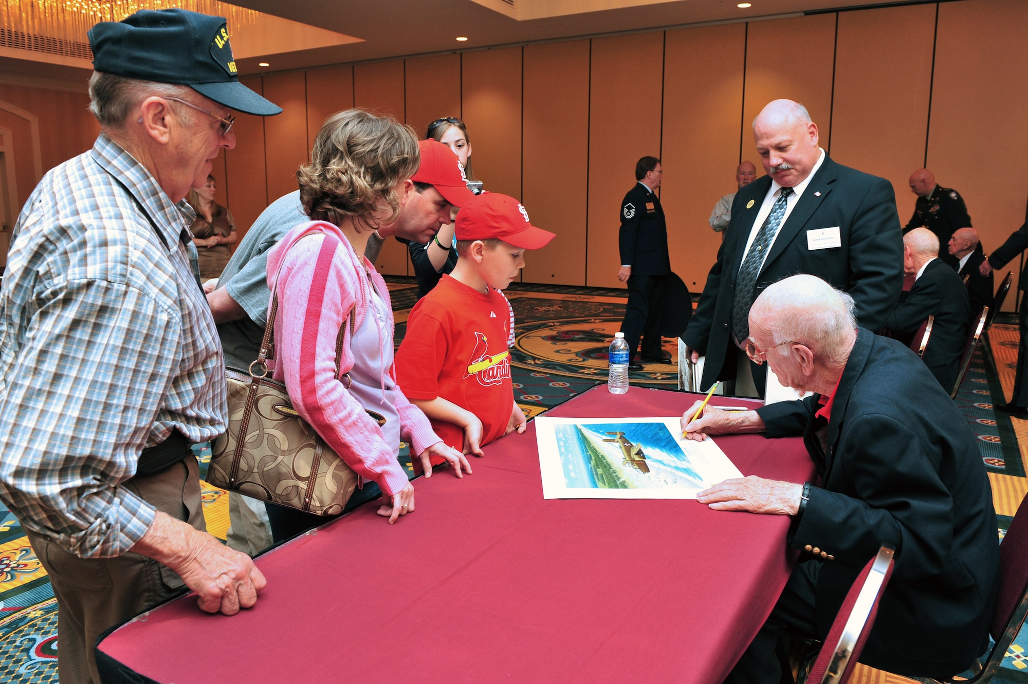 Thomas Griffin, a Doolittle Raider, signs autographs after a luncheon April 17 in Columbia, S.C., during the 67th Doolittle Raider reunion. Mr. Griffin was a navigator for crew no. 9. In 1943, he was shot down over Germany and captured and held prisoner until April 1945. (U.S. Air Force photo/Senior Airman William Coleman)