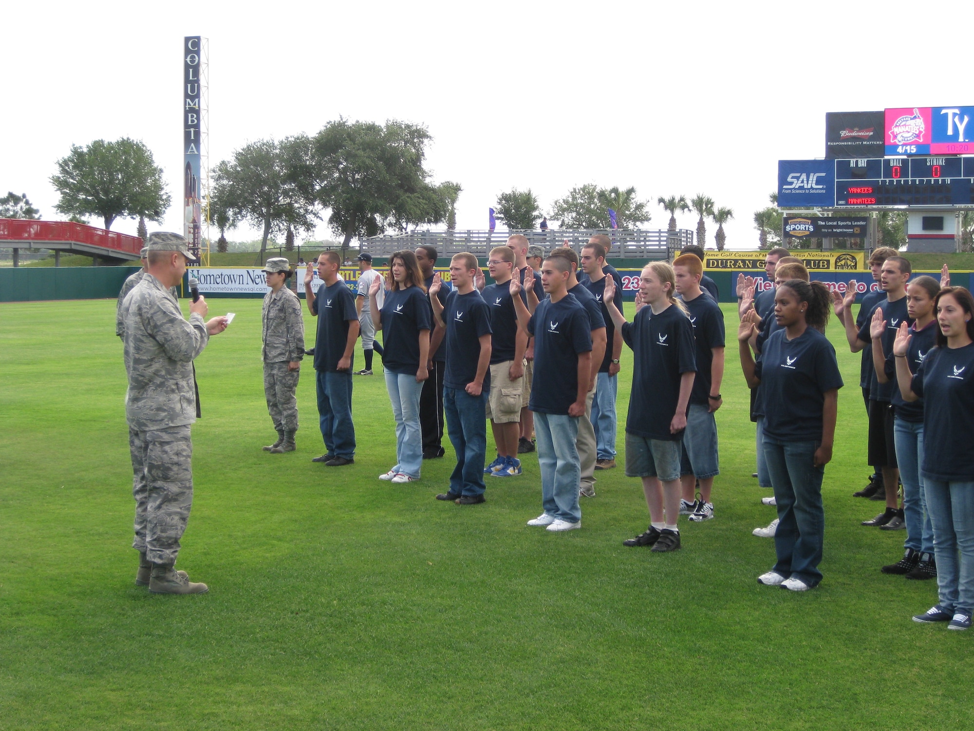 Col. Michael Brice administers the oath of enlistment to 47 young men and women April 15 before baseball fans at a Brevard Manatees minor league game in Melbourne, Fla. Colonel Brice is the commander of the 369th Recruiting Group. (U.S. Air Force photo)