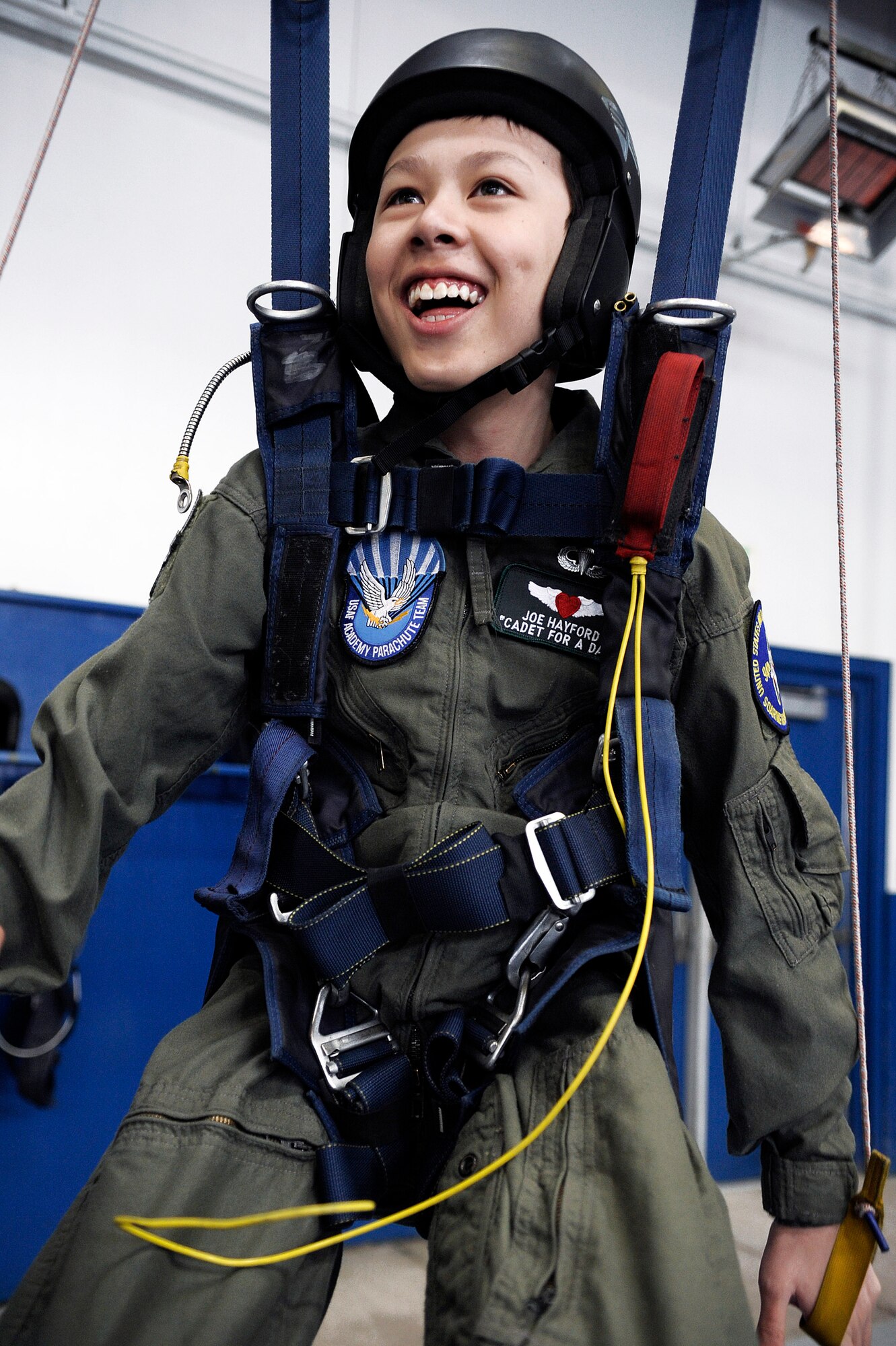 Cadet for a Day Joe Hayford enjoys the parachute ground training facility as part of his tour of the U.S. Air Force Academy April 10. Cadet squadron 4 sponsored his visit which was organized by the Make-A-Wish foundation.  (U.S. Air Force photo/Mike Kaplan)