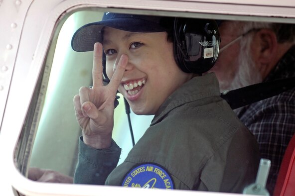 Cadet for a Day Joe Hayford signals to his family as he prepares for an aero club flight during his visit to the Air Force Academy April 10.  Organized through the Make-A-Wish Foundation, Joe was sponsored by cadet squadron 4 during his visit. (U.S. Air Force photo/Mike Kaplan)