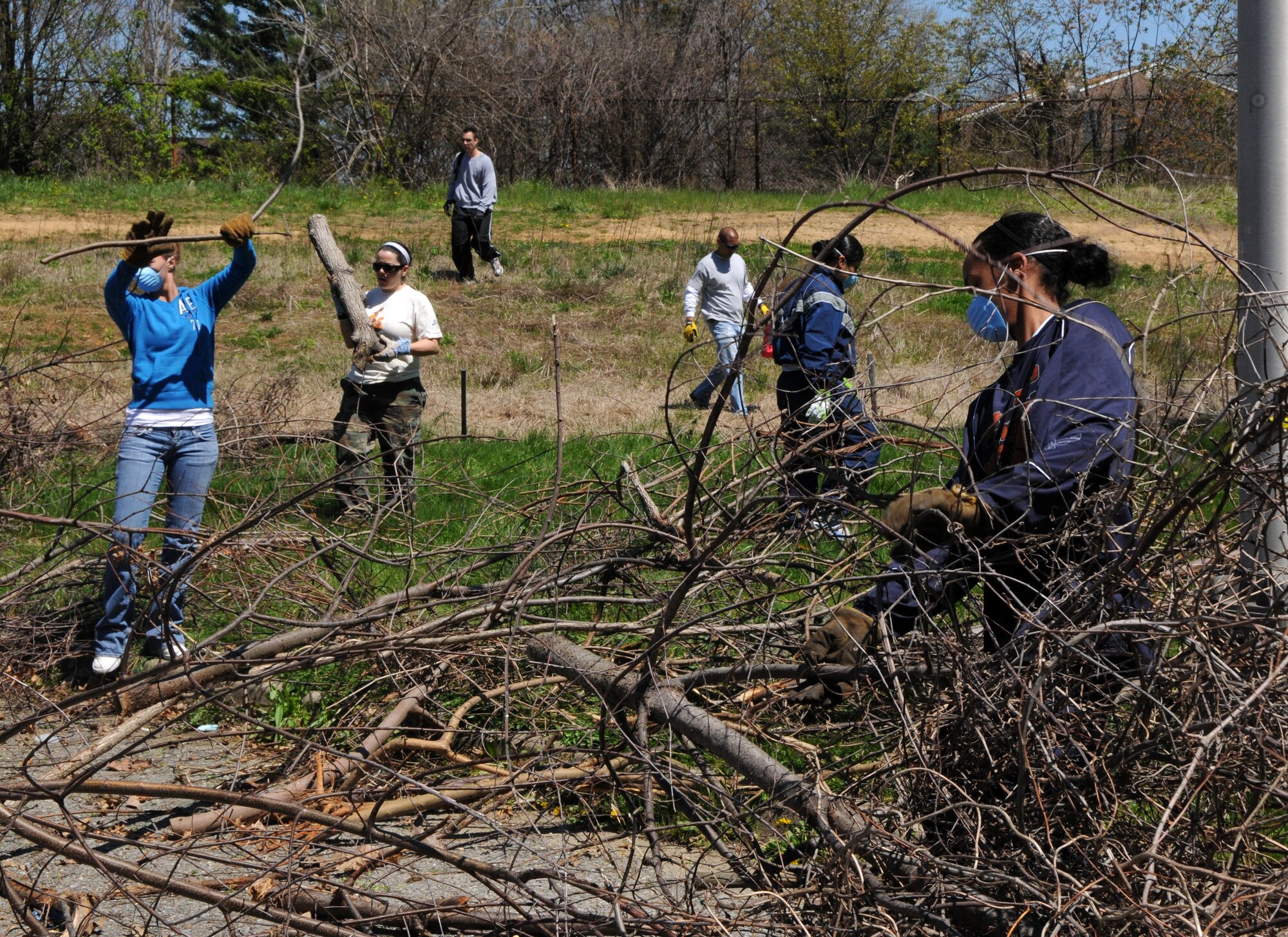 Air Force and Coast Guard members gather branches and vines to be sent through the wood chipper April 17 in one of the historic cemeteries at Saint Elizabeth’s Hospital, Washington, D.C. Volunteers from Bolling, including Coast Guard members, dedicated their time to help Saint Elizabeth’s clear out overgrown brush and vines, and pick up trash in preparation to restoring their cemetery. The cemetery is the final resting place of nearly 4,000 veterans – 1,871 military veterans from the Civil War, War of 1812, Spanish-American War and World War I and 2,000 that fought a battle against mental illness. (U.S. Air Force photo by Senior Airman Marleah Miller)