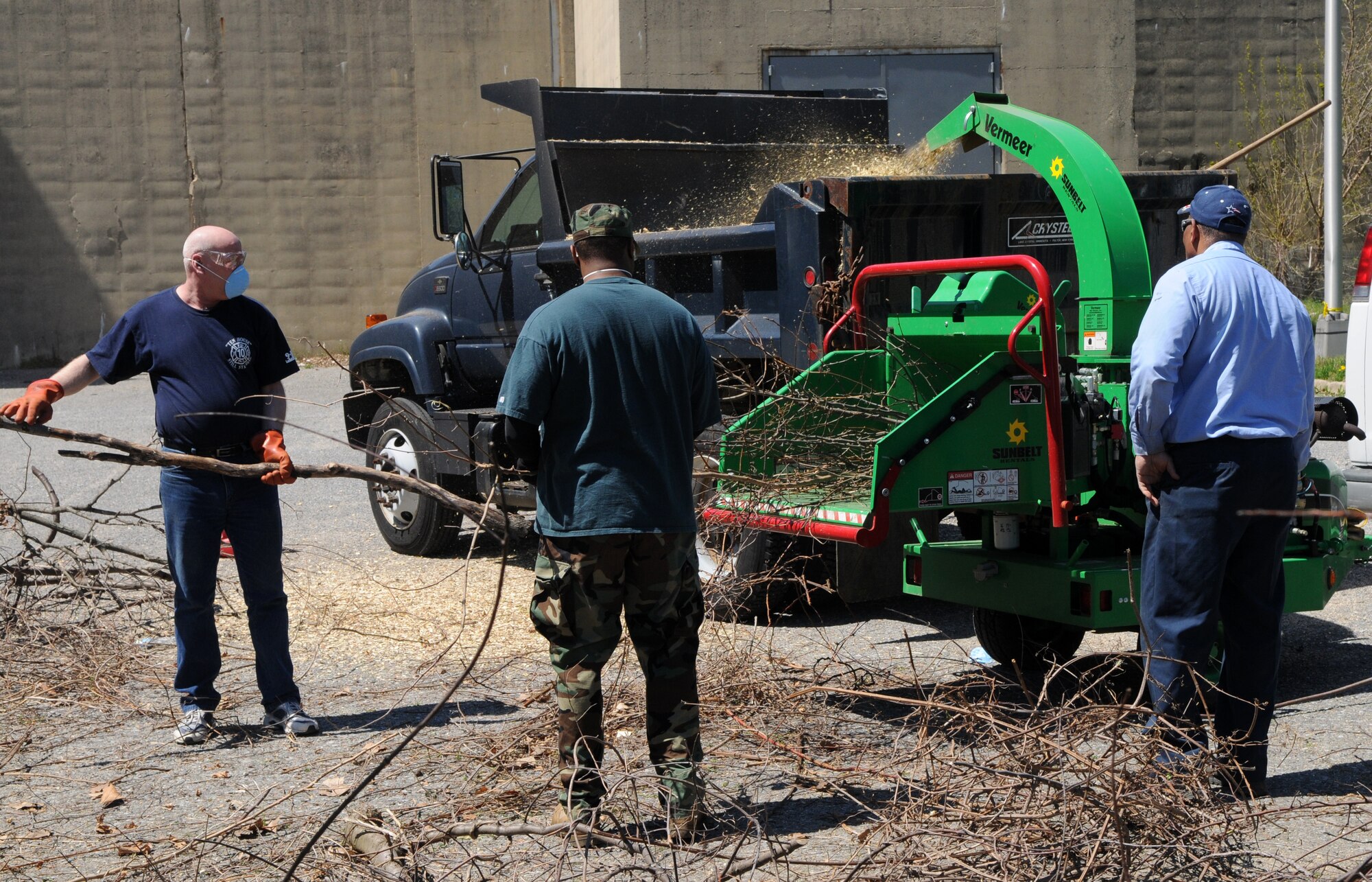 Tech. Sgts. Russell Wolfrom, 11th Wing Command Post, and Edward Hill, Air Force Legal Operations Agency, send branches through the wood chipper April 17 at Saint Elizabeth’s Hospital, Washington, D.C. Volunteers from Bolling, including Coast Guard members, dedicated their time to help Saint Elizabeth’s clear out overgrown brush and vines, and pick up trash in preparation to restoring their cemetery. The cemetery is the final resting place of nearly 4,000 veterans – 1,871 military veterans from the Civil War, War of 1812, Spanish-American War and World War I and 2,000 that fought a battle against mental illness. (U.S. Air Force photo by Senior Airman Marleah Miller)